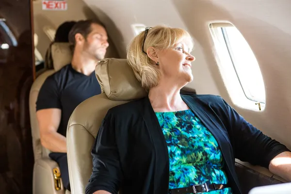 Business People Relaxing On Private Jet