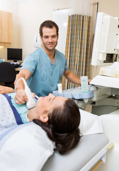 Nurse Performing Ultrasound On Patient's Neck