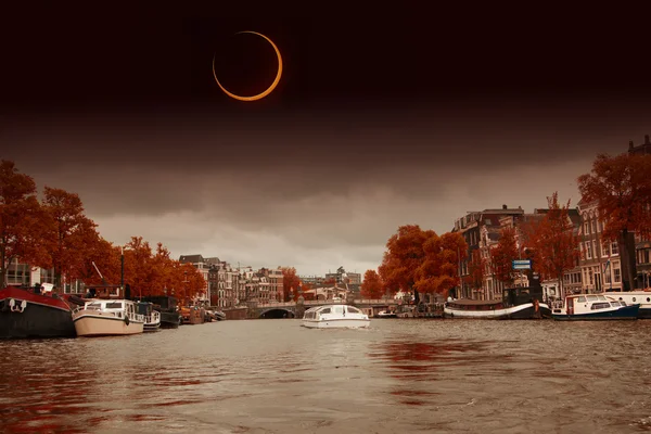 Solar Eclipse over the city Amsterdam. Elements of this image fu