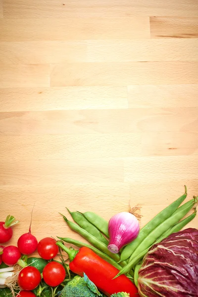 Healthy organic vegetables on a wood background