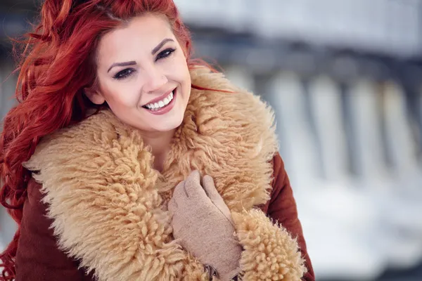 Girl with red hair in the winter