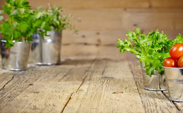 Fresh herbs on a rustic table in late day sunlight