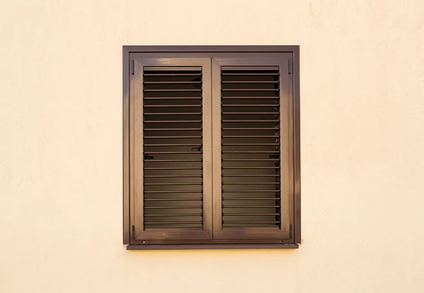 Detail of a window with shutters closed