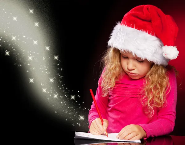 Girl writing a letter to santa claus