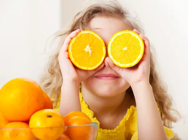 Child with oranges