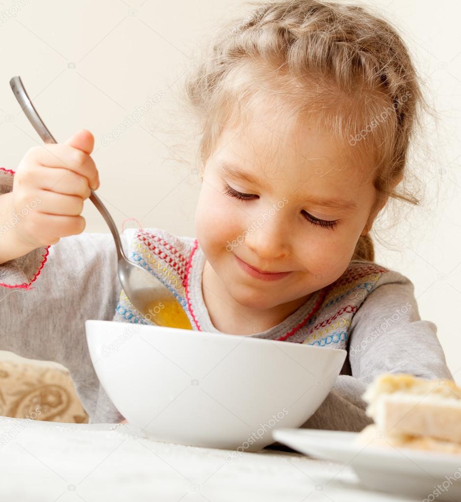Little girl eating soup — Stock Photo © TatyanaGl 12159919