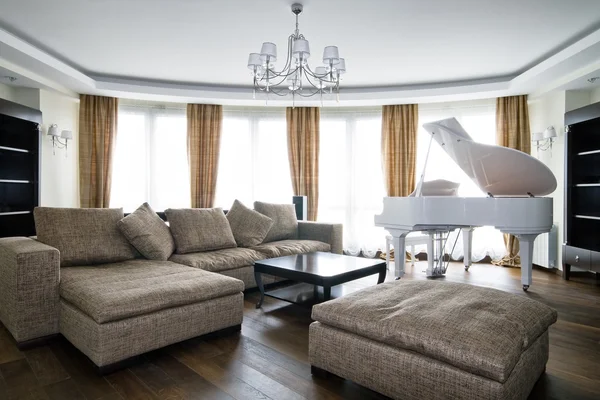 Interior of light living room with white piano