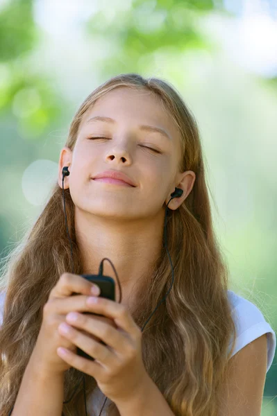 Teenage girl with headphones listening to music
