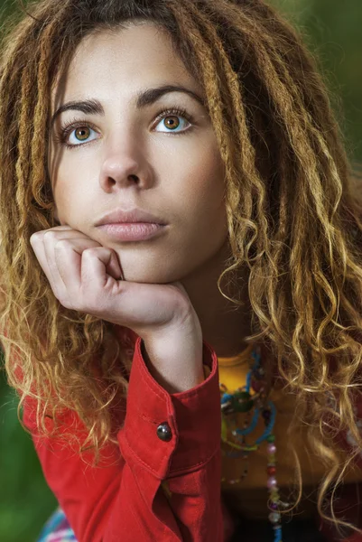 Pensive woman with dreadlocks closeup