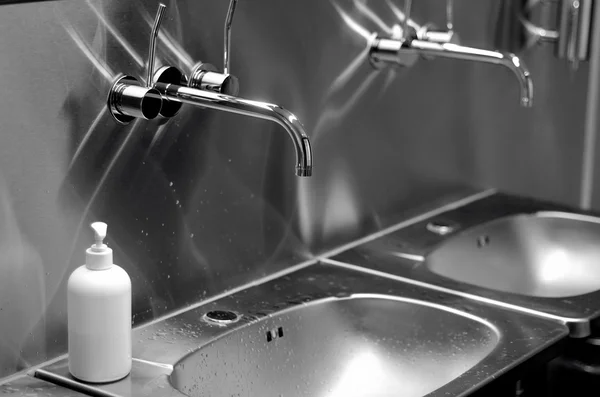 Faucets, sinks and liquid soap in a toilet