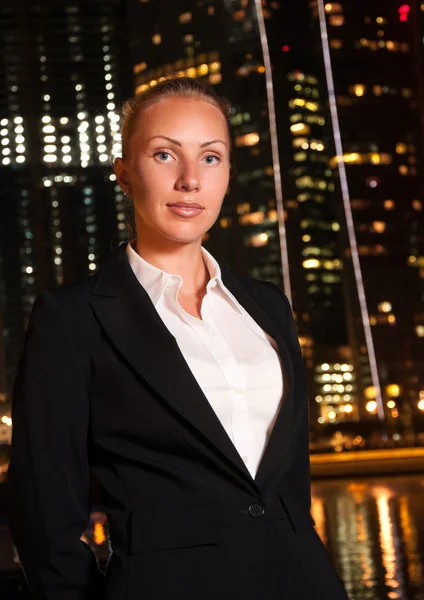 Young business woman in the big city at night