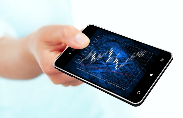 Hand holding mobile phone with stock market chart