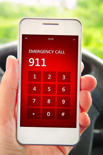 Hand holding mobile phone with emergency number 911