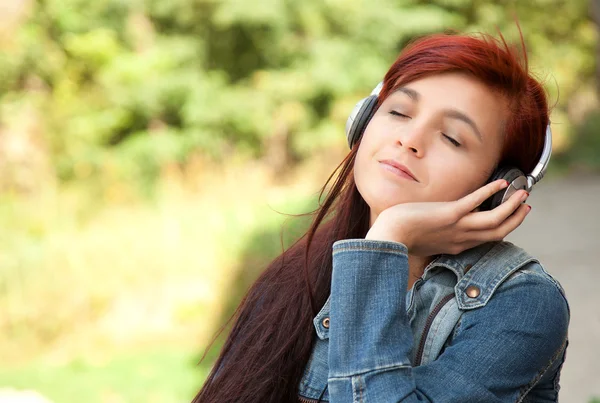 Pretty young girl listening to music