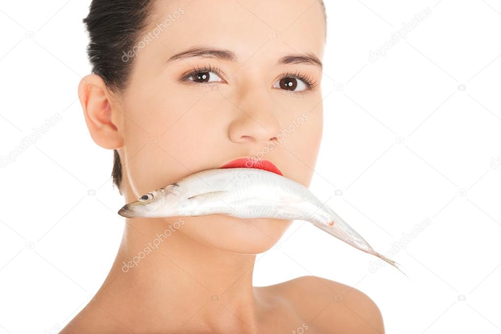 Beautiful Woman With Fish In Her Mouth Stock Photo Piotr Marcinski