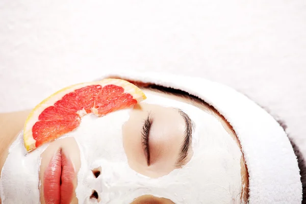 Attractive young woman with fruit mask