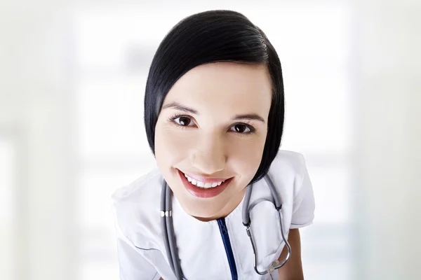 Nurse or young doctor standing smiling.