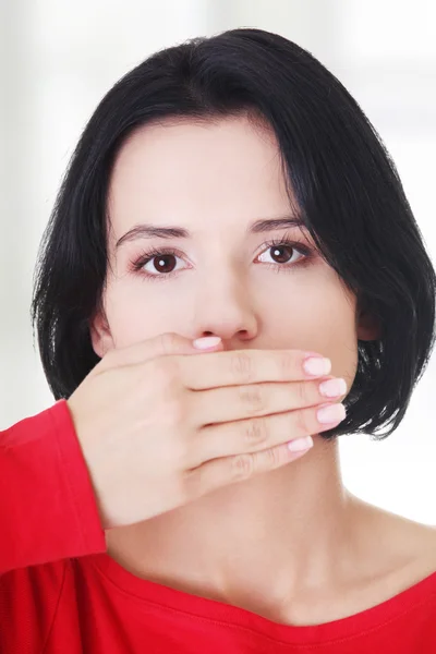 Teen woman covering mouth with hand