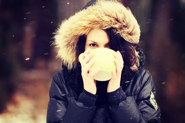 Woman with mug of hot drink