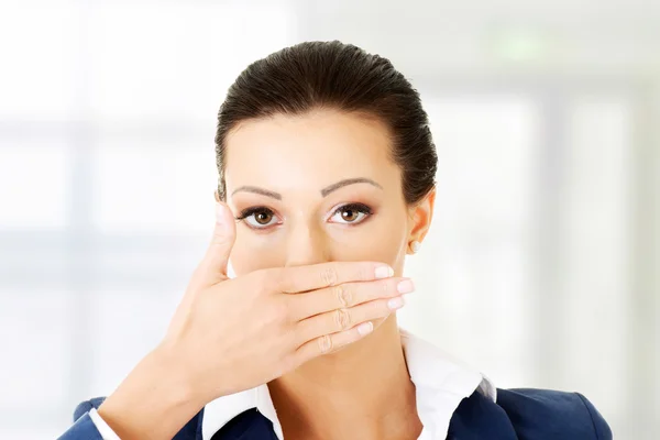 Young business woman covering her mouth