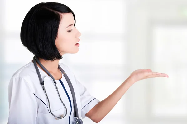 Medical doctor woman presenting and showing copy space