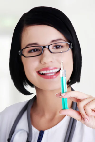 Happy medical doctor or nurse with syringe