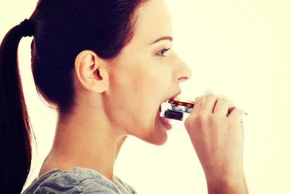 Woman trying to eat pills.