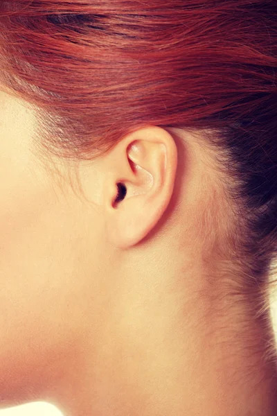 Young caucasian woman ear .