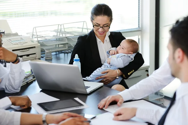 Business taking care of baby in office