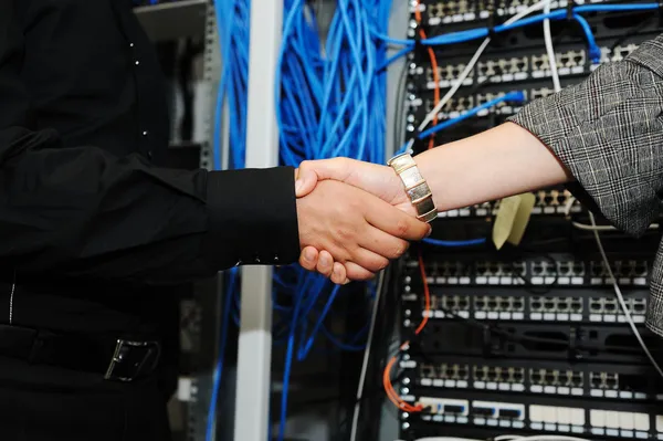 Handshaking at server room, man and woman