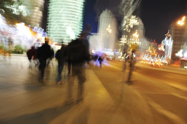 Crowd walking in the city at night (blurred scene)