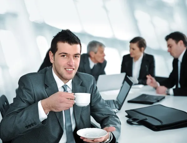 Businessman in business ambience drinking cofee
