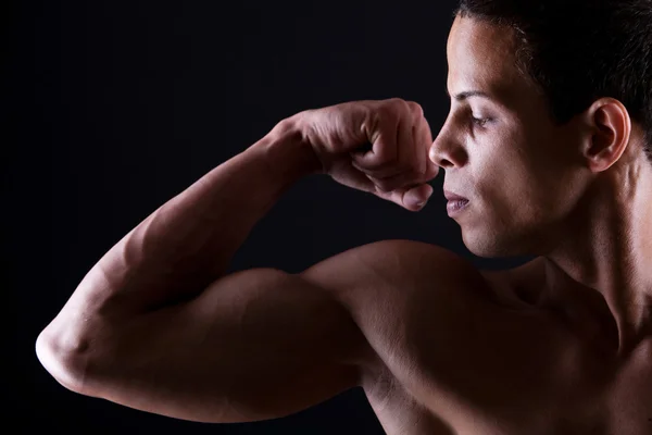 Muscular man showing his strong biceps