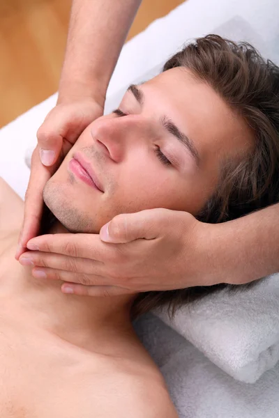 Handsome man enjoying face massage