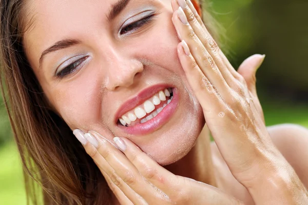 Beautiful woman washing her face — Stock Photo #12794502