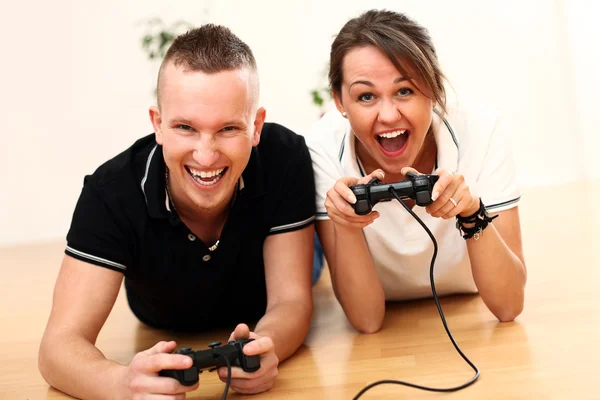 Young couple emotionally play video games at home