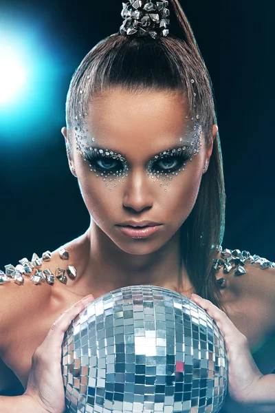 Woman with artistic make-up and discoball