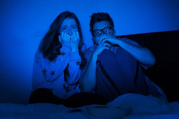 Caucasian couple watching scary movie