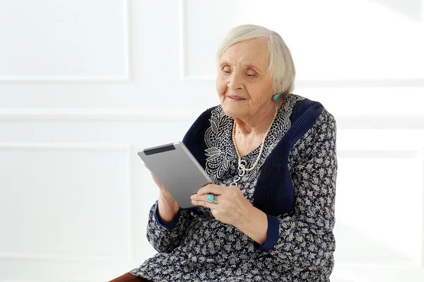 Elderly woman with tablet