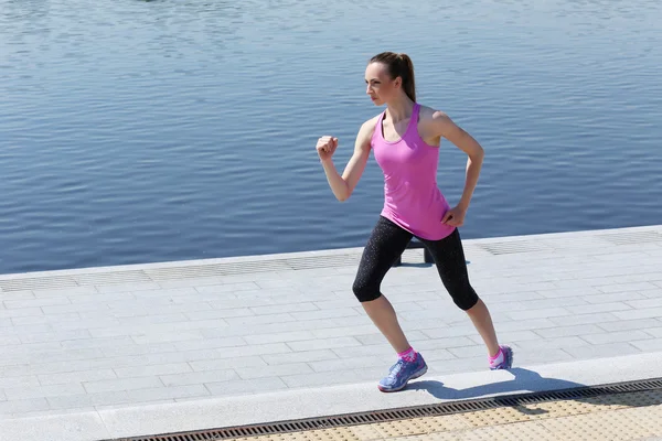 Cute woman running on the street