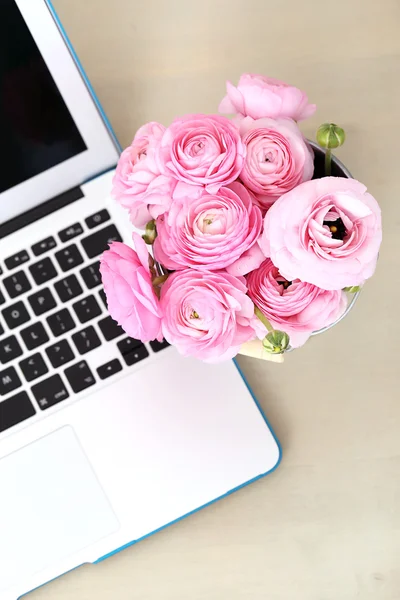 Pink roses bouquet with laptop