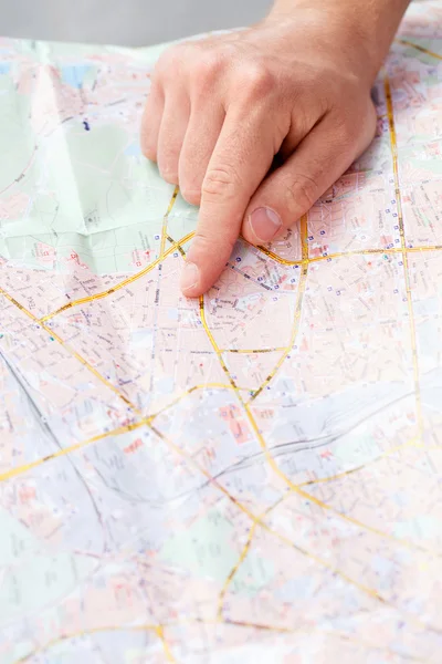 Tourist pointing in map
