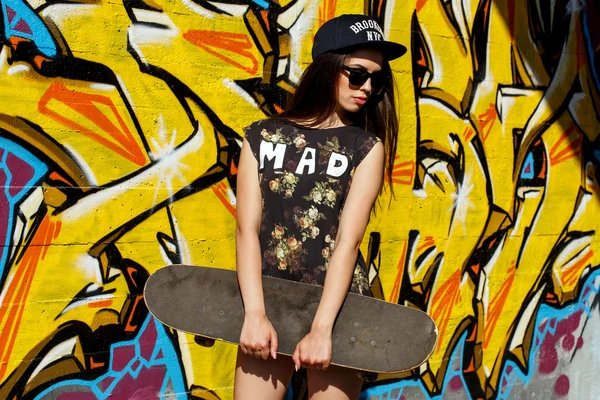 Teen in a cap with skateboard