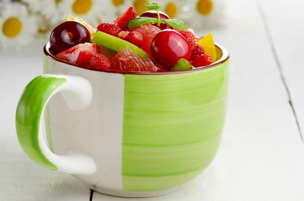 Green cup with fruits