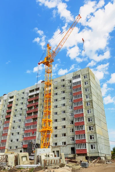 Dwelling house and tower crane on the construction site