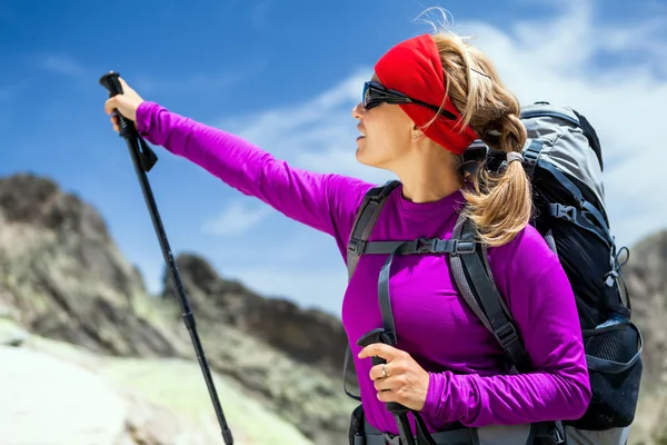 Woman hiking with backpack in mountains