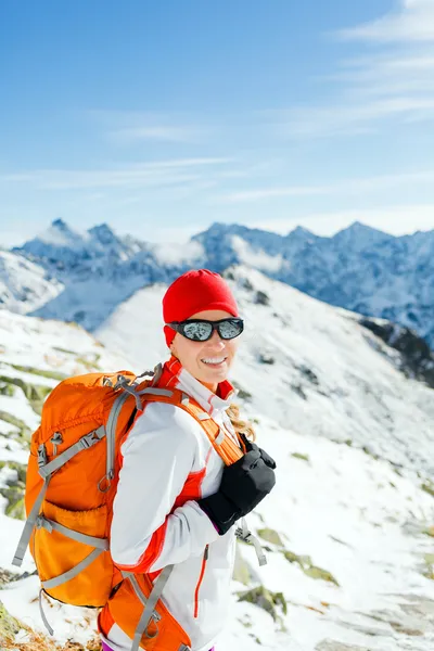 Hiking and walking woman in winter mountains