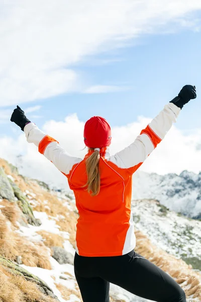 Hiking success, woman in winter mountains
