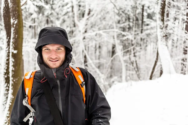 Man hiking in winter forest