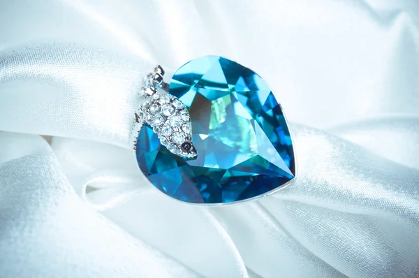 Blue gem ring on white background